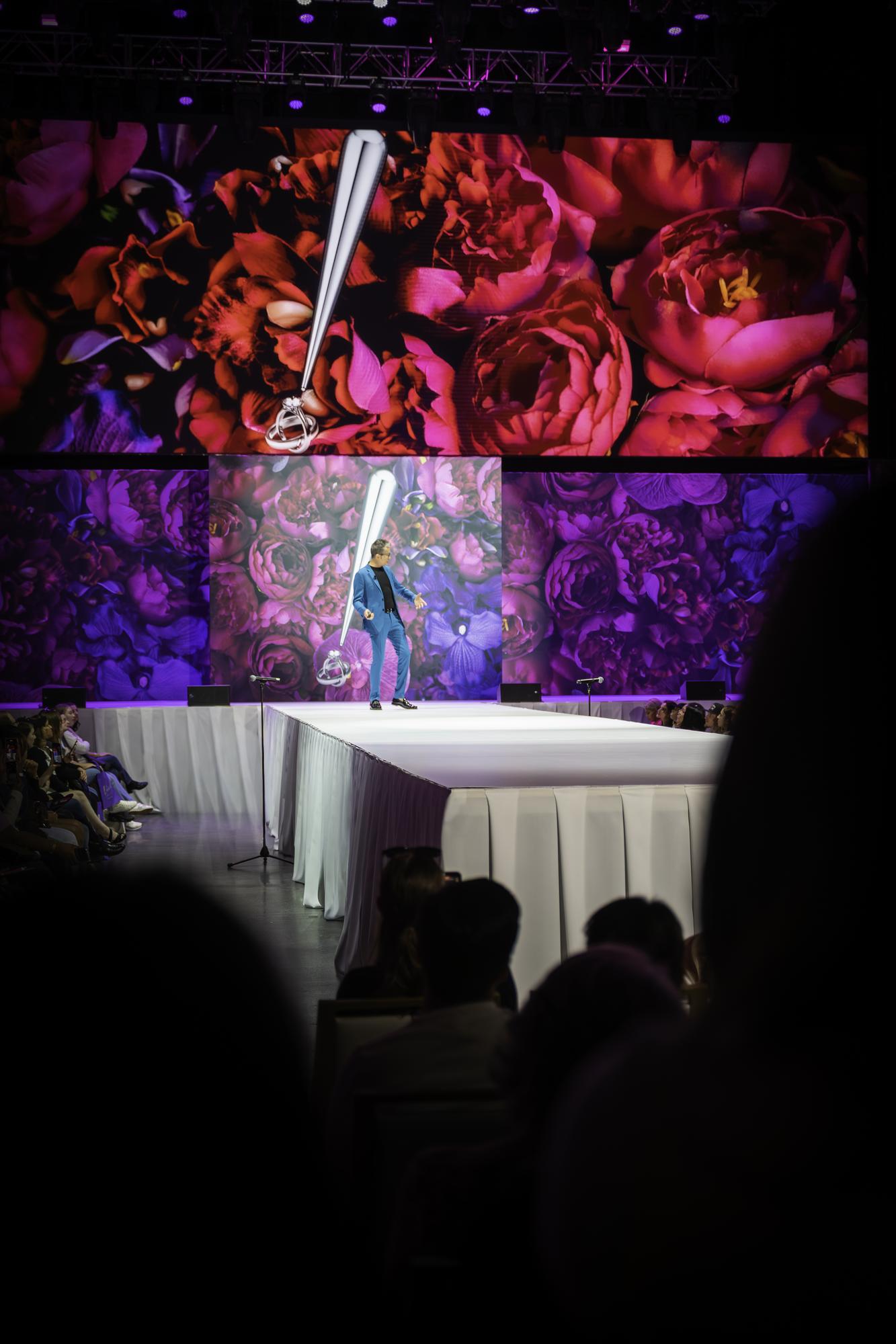 Randy Fenoli portrait on the catwalk, theatrical ring descending, deep floral LED backdrop, Randy Fenoli Wedding Showcase at Live! Casino Maryland, EventPro production