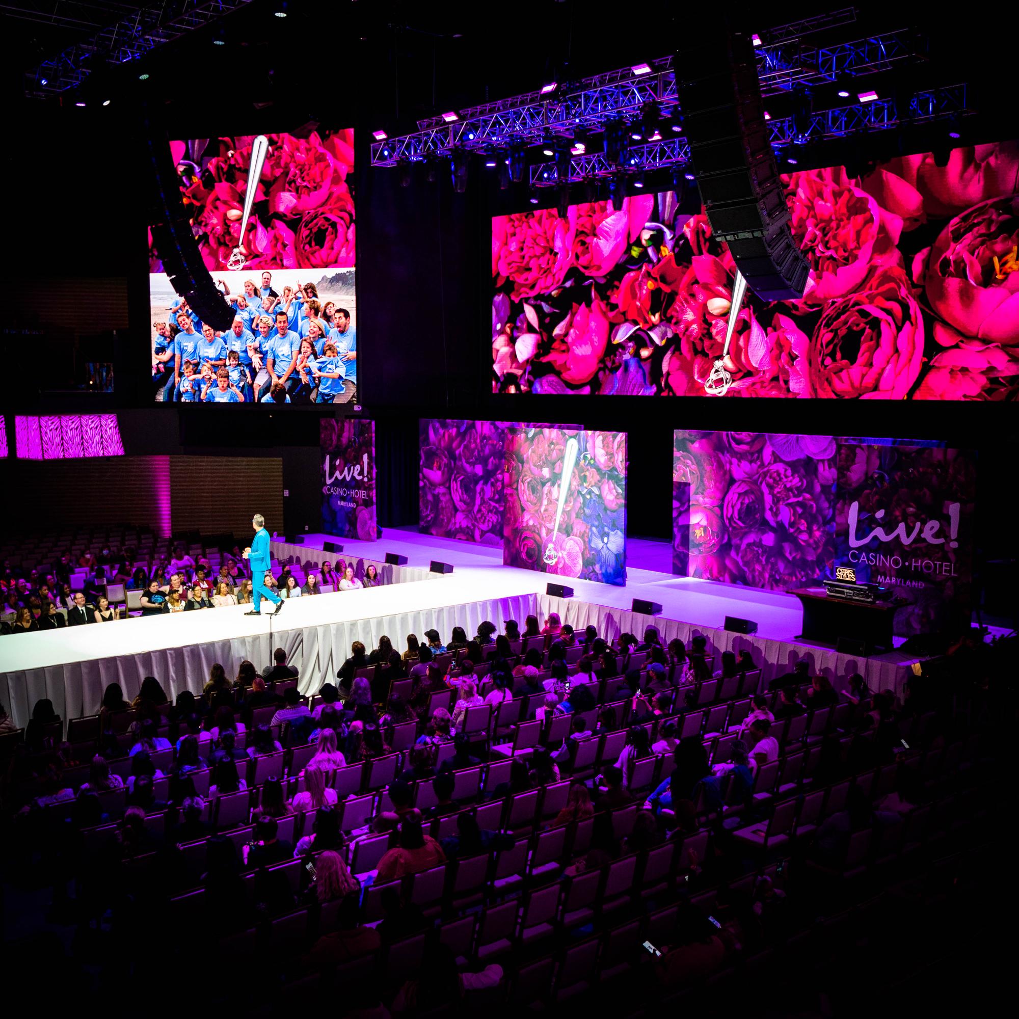 Establishing shot, Randy Fenoli on catwalk, full audience, LED video walls with Live! Casino Hotel branding, Randy Fenoli Wedding Showcase, Hanover Maryland