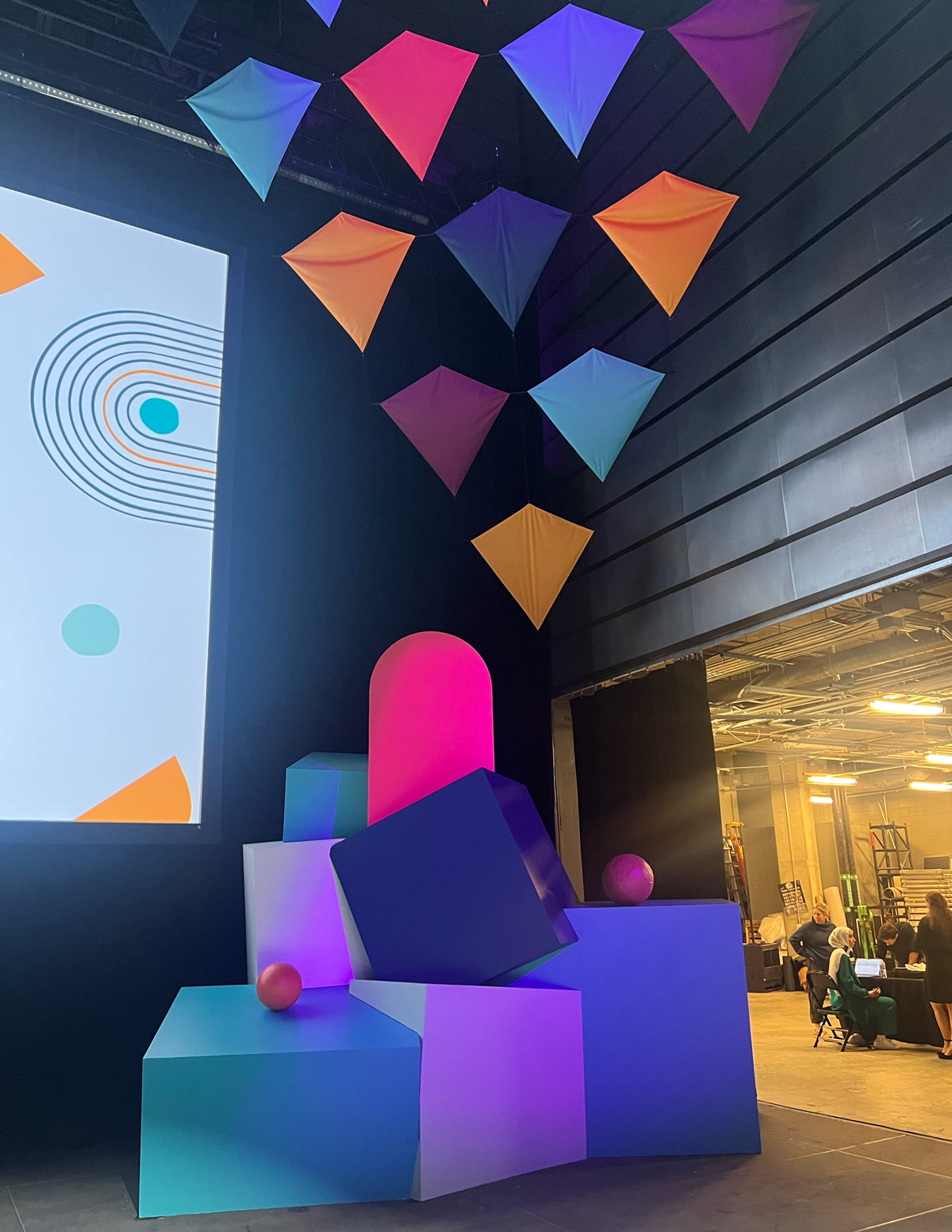 Stage scenic detail — Connect Accept Empower dimensional gold letters above LED wall, Embassy of Qatar Autism Society branding