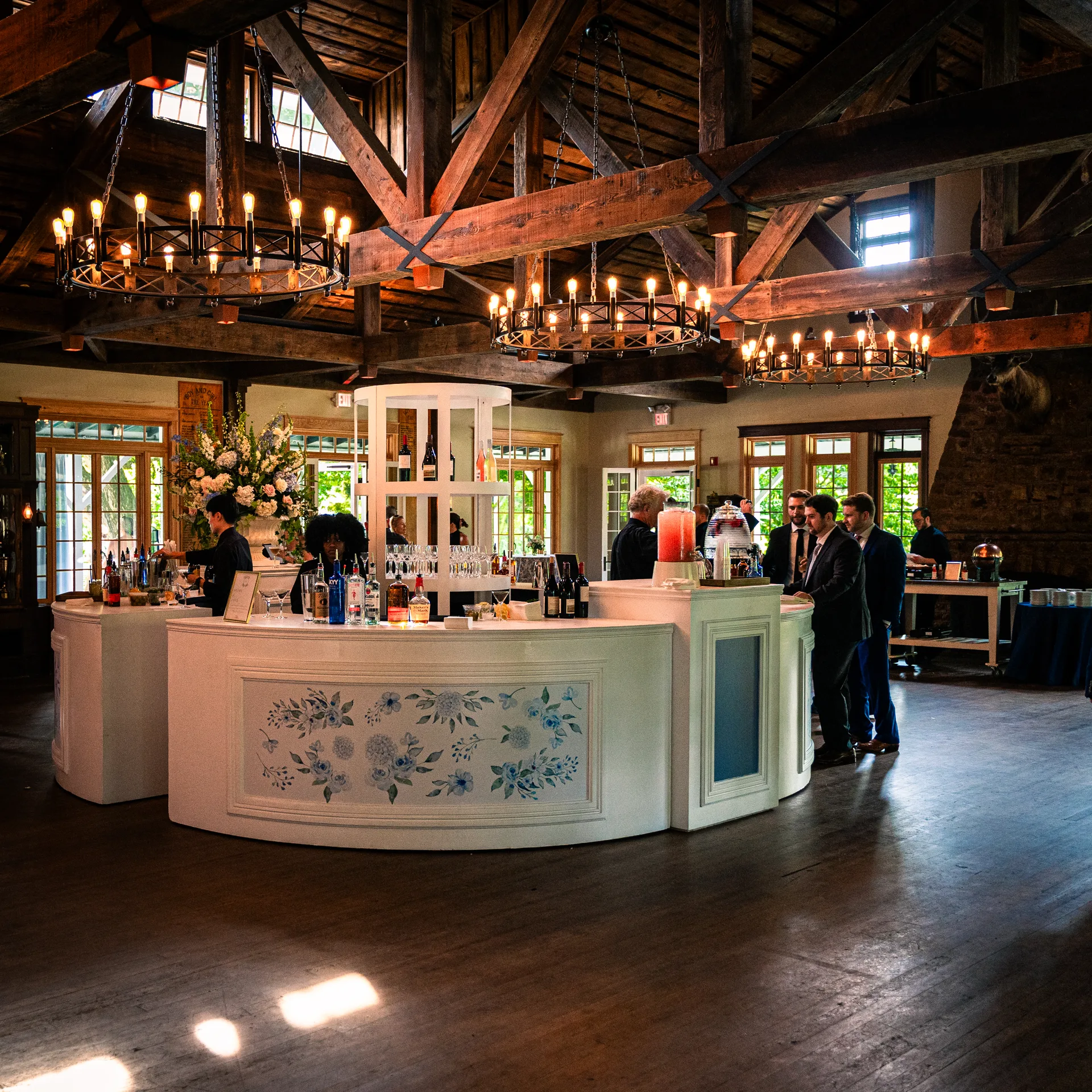 Custom curved cocktail bar at Sherwood Forest wedding, white bar with hand-painted watercolor floral panels, cocktail hour setup, EventPro bar fabrication Sherwood Forest Maryland