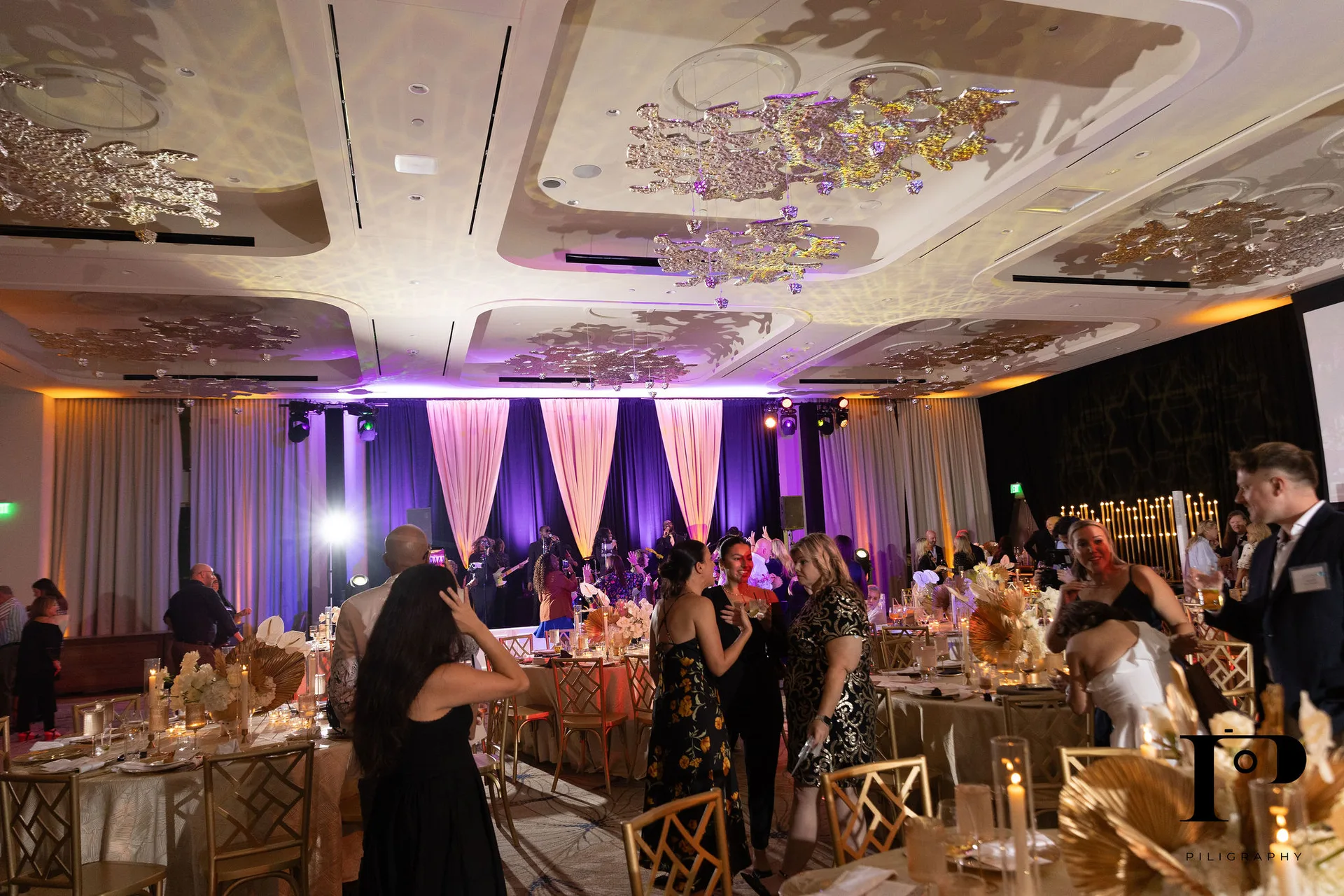 NACE South Florida gala reception in full swing, purple and amber color wash lighting, guests at tables, EventPro lighting production Pier 66 Fort Lauderdale