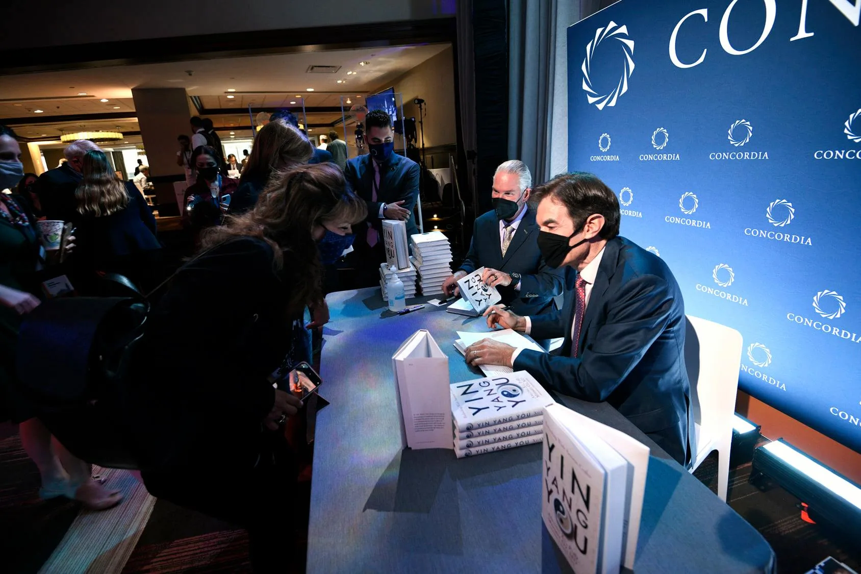 Book signing in the foyer at Concordia Annual Summit 2021, Concordia step-and-repeat backdrop printed and installed by EventPro, guests queued for signing, Sheraton Times Square New York