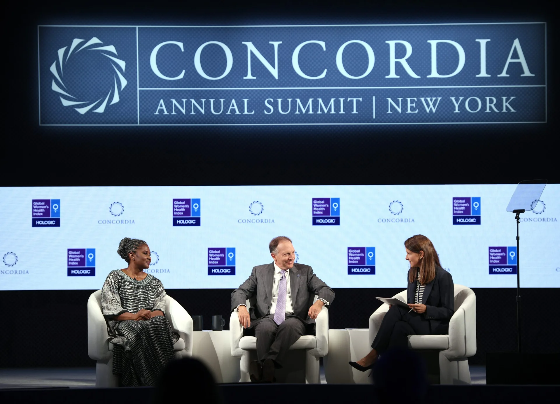 Three-speaker panel at Concordia Annual Summit 2021, Hologic and Global Women's Health Index sponsor step-and-repeat, Concordia LED wall, EventPro stage build New York