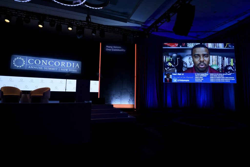 Hybrid session at Concordia Annual Summit 2021, virtual presenter displayed on LED wall, custom armchair seating on stage, EventPro stage build and scenic set Sheraton Times Square New York