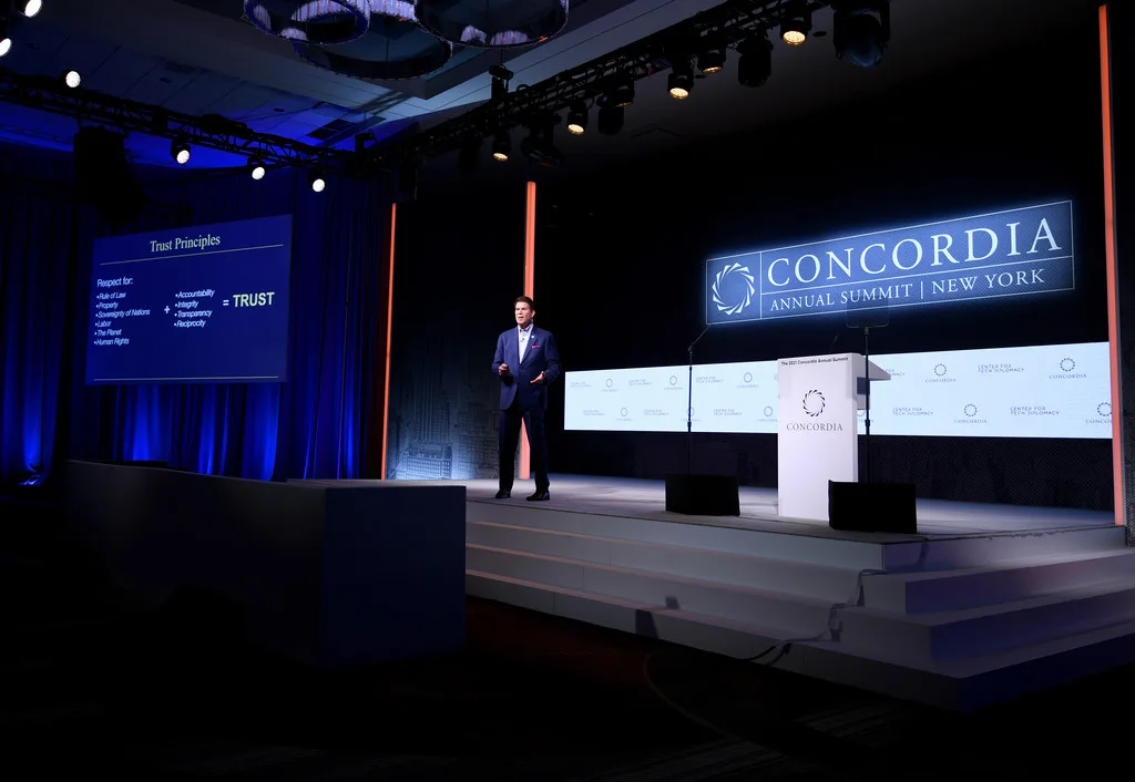 Concordia Annual Summit 2021, speaker at custom Concordia lectern, full LED wall lit with Concordia branding, EventPro stage build and scenic set construction, Sheraton Times Square New York