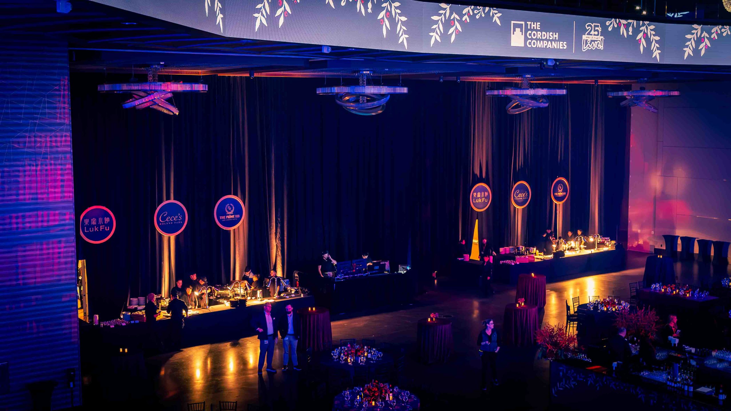 Aerial view of branded dinner station row, LukFu, Cece's, and The Prime Rib circular medallion signage, Cordish Companies holiday party, EventPro Maryland