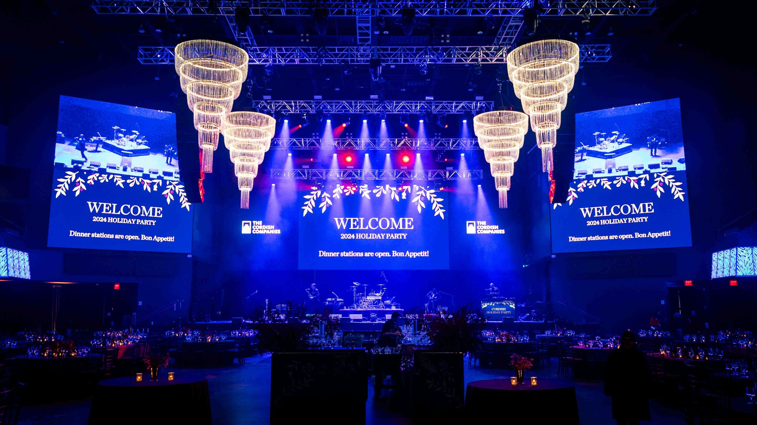 Full ballroom with three LED video walls and crystal chandeliers, Cordish Companies 2024 Holiday Party at Live! Casino Maryland, produced by EventPro