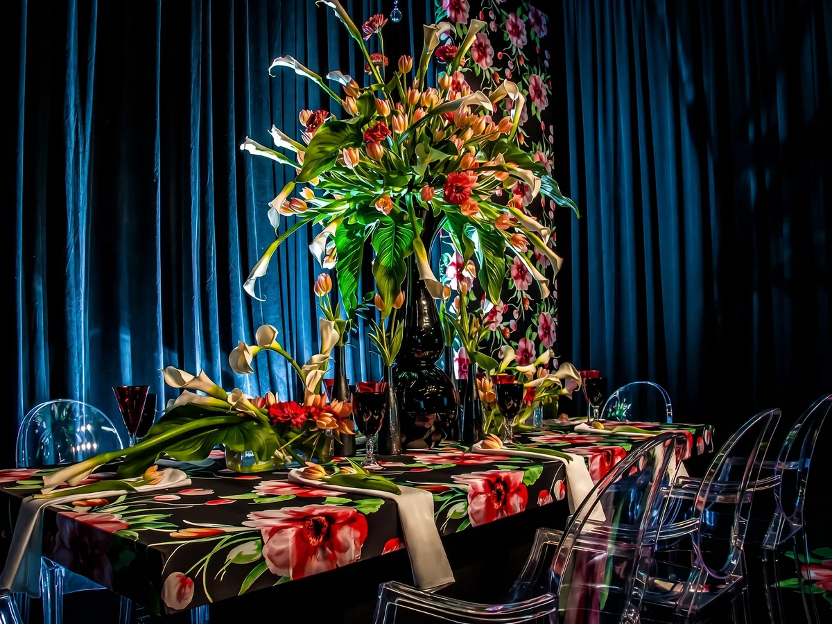 Custom event centerpiece with tall floral arrangement and styled tablescape by Event Pro