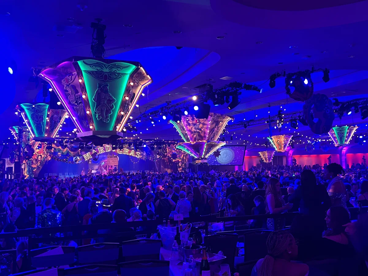 Suspended aerial decor elements at a Mardi Gras themed corporate event