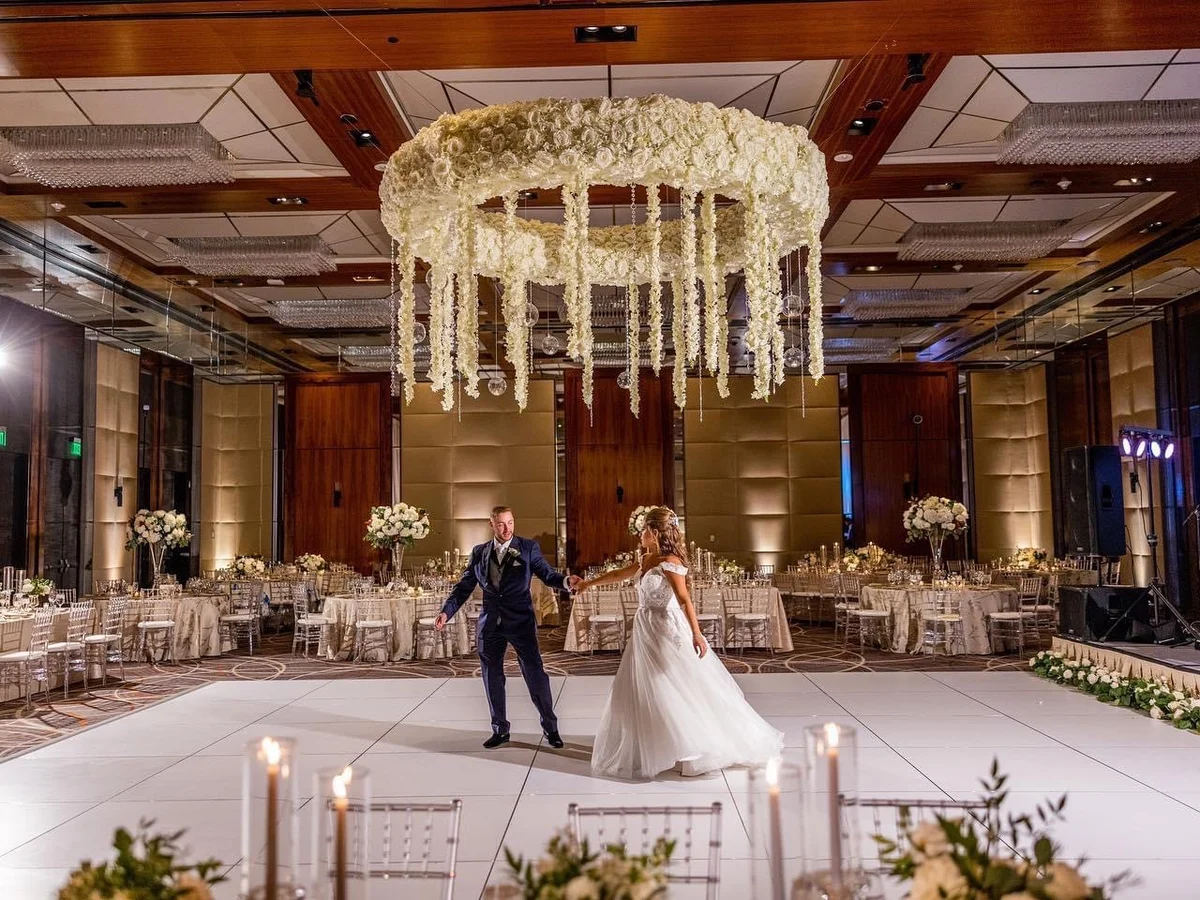 Large-scale hanging floral ring installation in ballroom by Event Pro