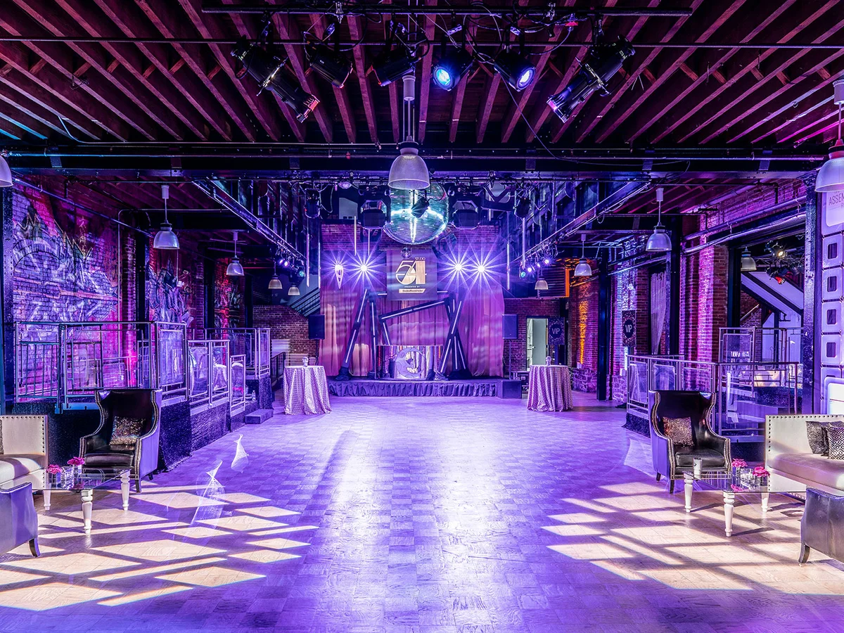 Purple wash and gobo lighting transforming an industrial venue by Event Pro