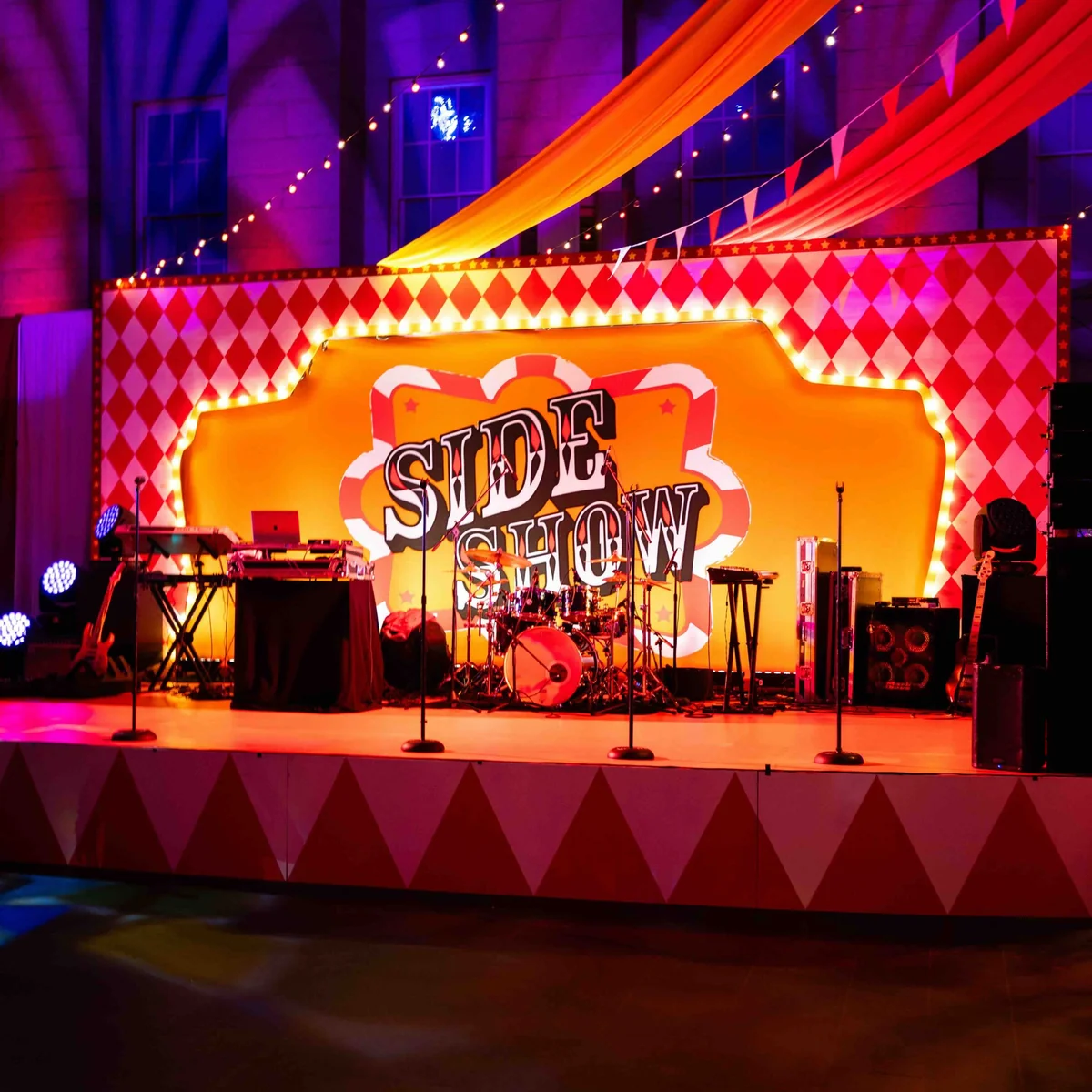 Full stage scenic graphic environment with printed harlequin backdrop and stage wrap at Kings Dinner DC Mardi Gras event by Event Pro