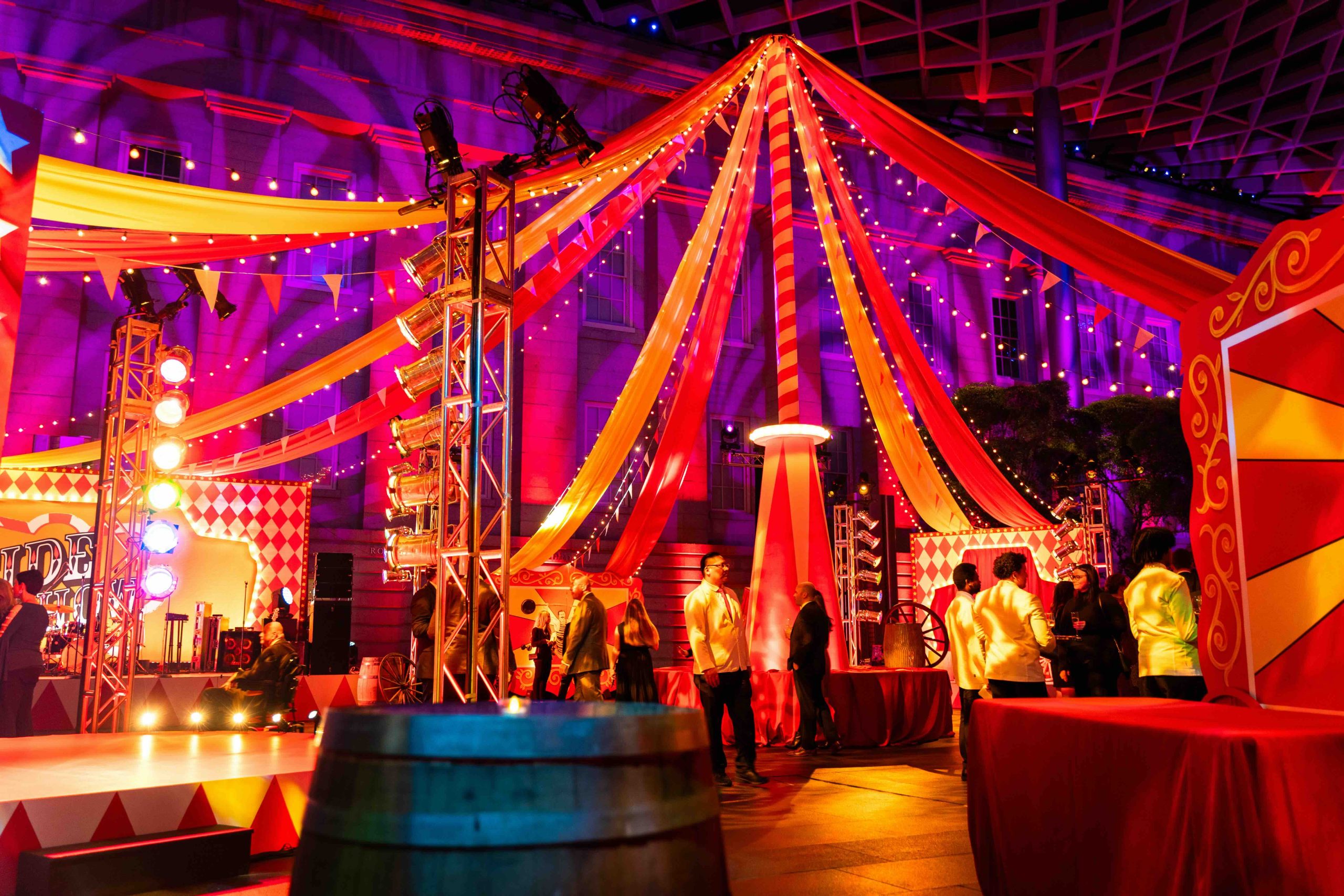 Truss lighting rigs and fabric tent canopy detail, carnival wagon wheels and themed set pieces, EventPro Kings Dinner DC Mardi Gras National Portrait Gallery 2025