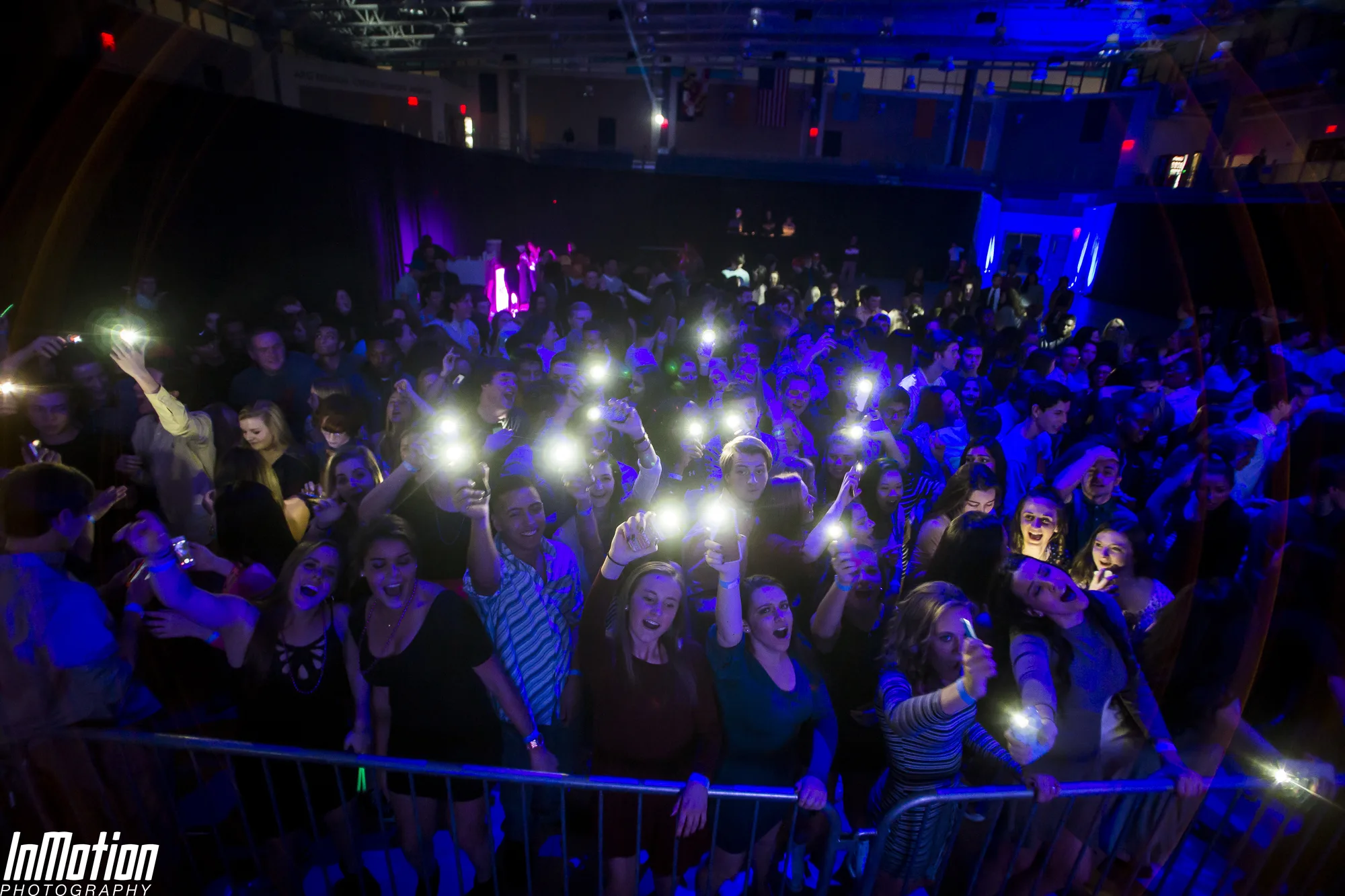 Crowd raising phone lights in the dark at Lights Out concert APGFCU Arena Maryland, atmospheric wide shot, EventPro concert production