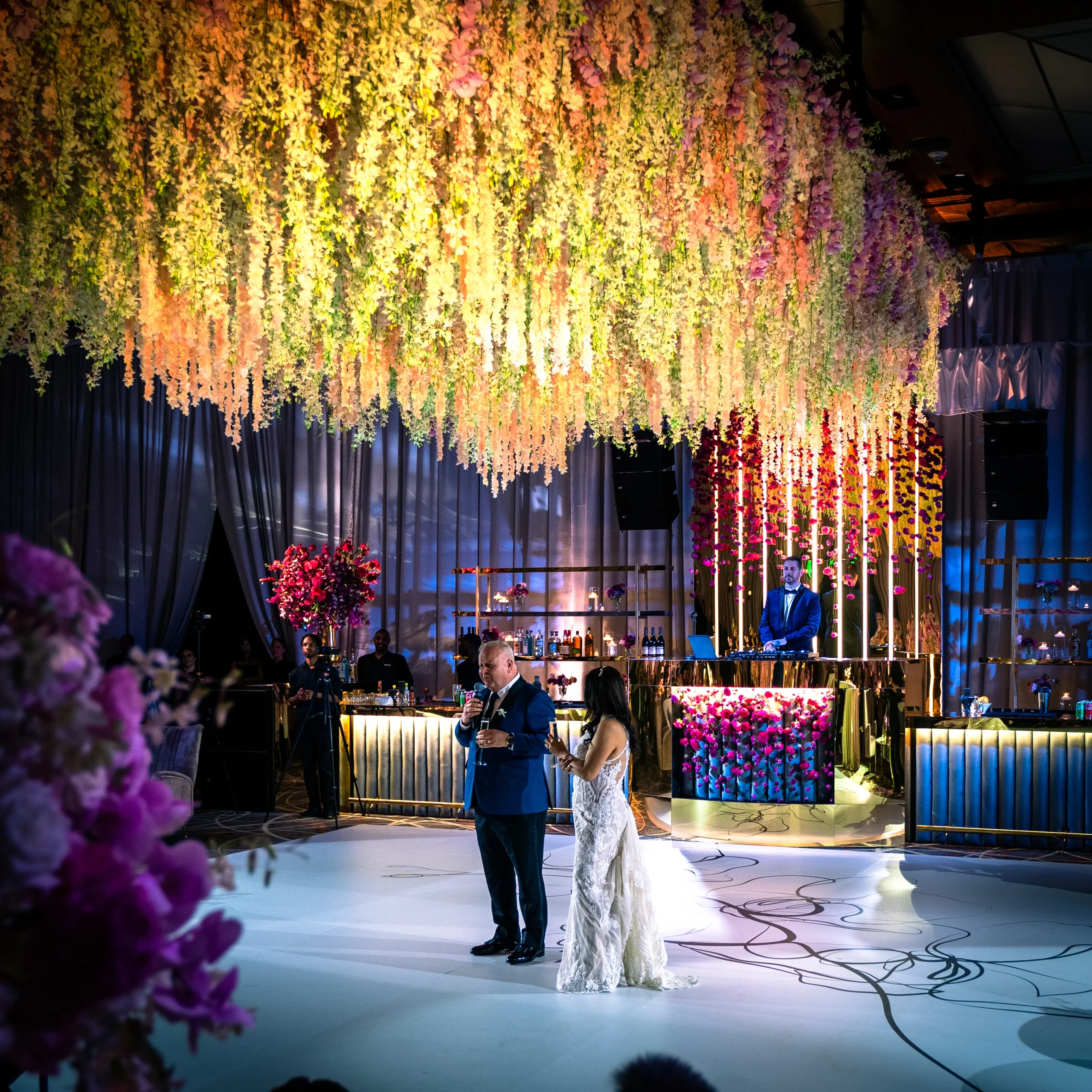 Luxury wedding first dance under custom floral ceiling installation — EventPro event production