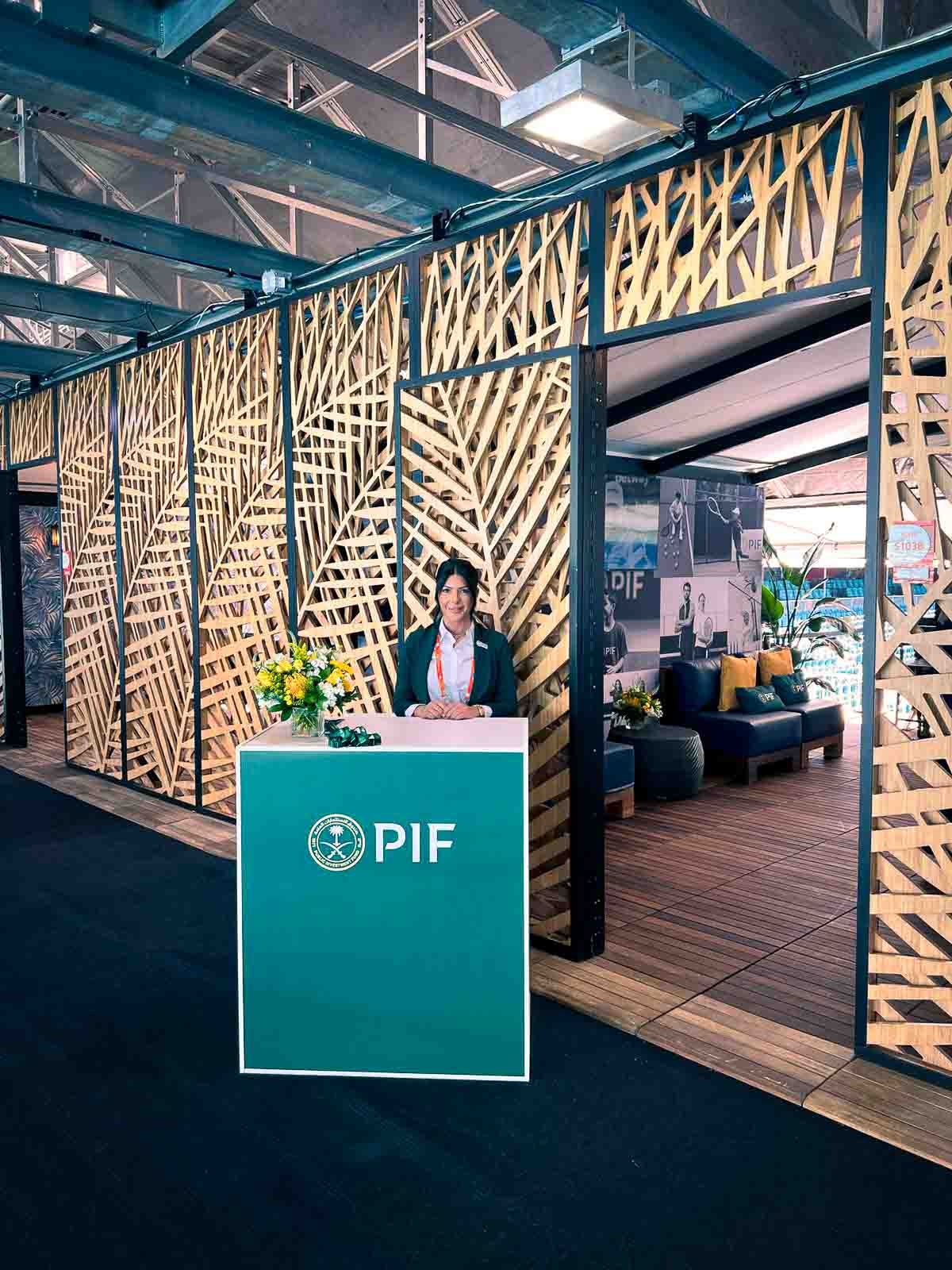 CNC-cut geometric wood lattice screening panels and PIF branded reception desk at the Miami Open brand activation entry, custom fabrication by EventPro
