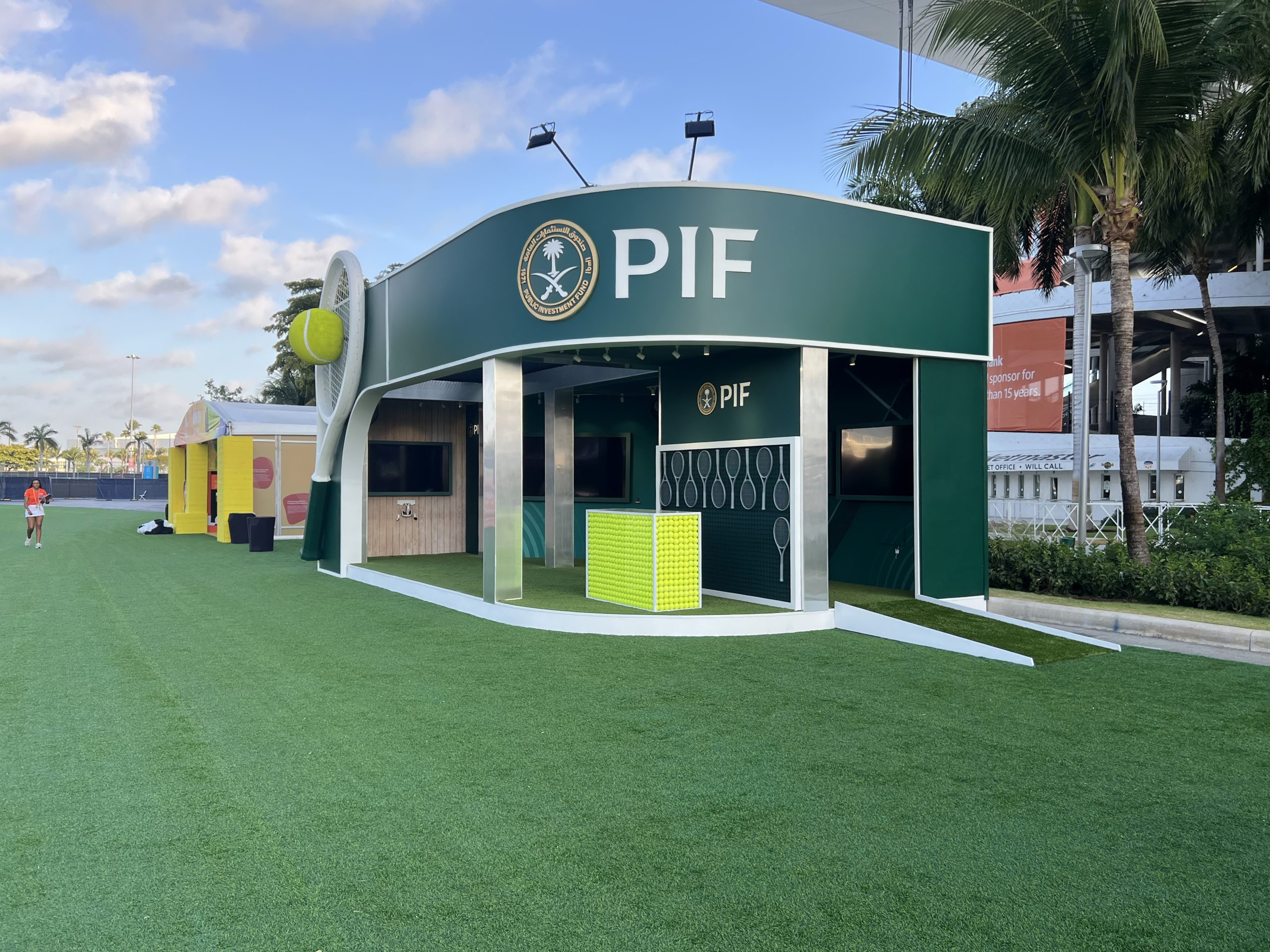 PIF brand activation pavilion full footprint at the 2025 Miami Open, custom fabricated structure with companion display wall and Hard Rock Stadium in background, EventPro Miami Gardens Florida