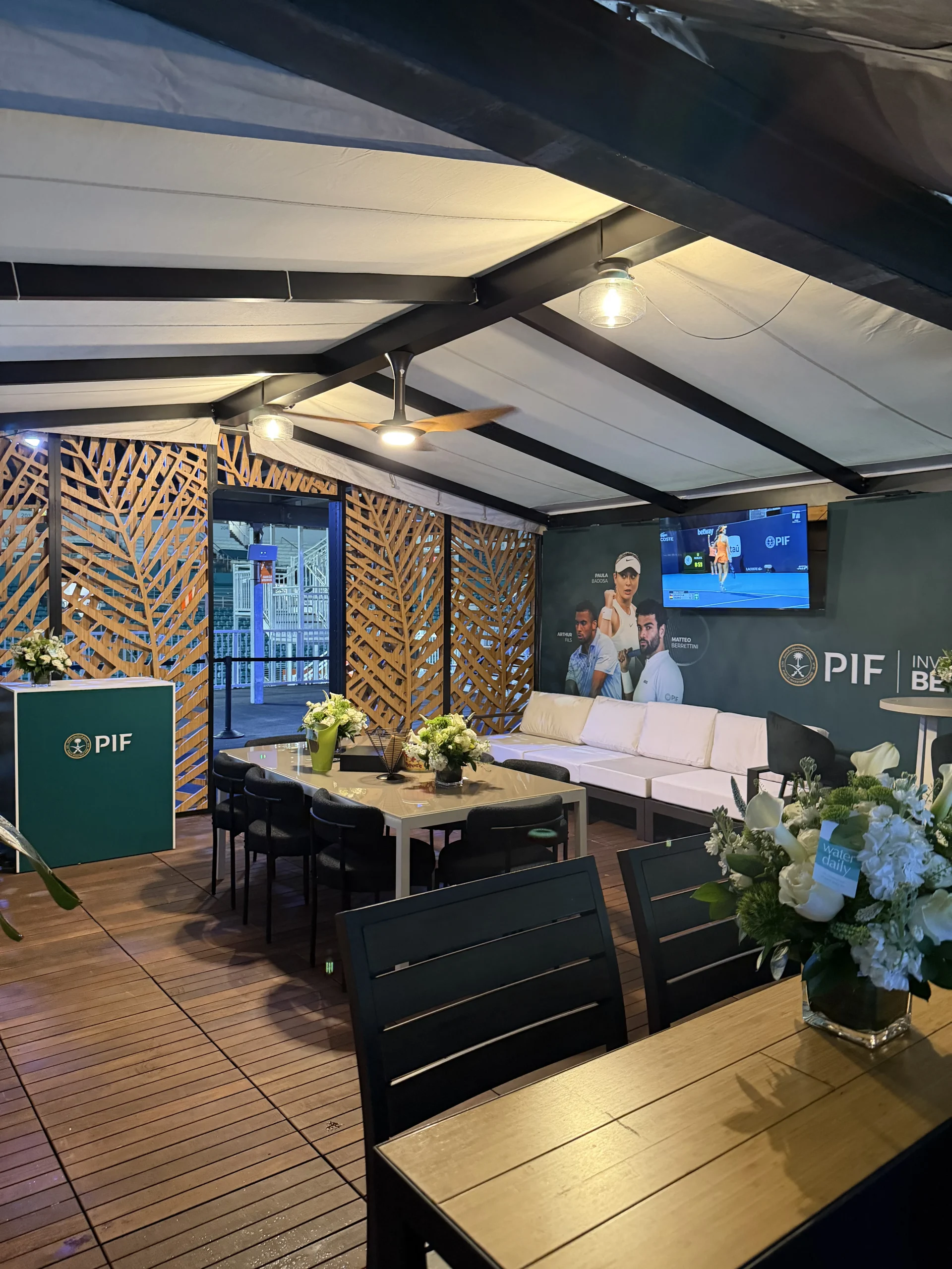 PIF suite cabana with palm leaf lattice panels, lounge furniture, and PIF branding, EventPro Hard Rock Stadium Miami Open 2026