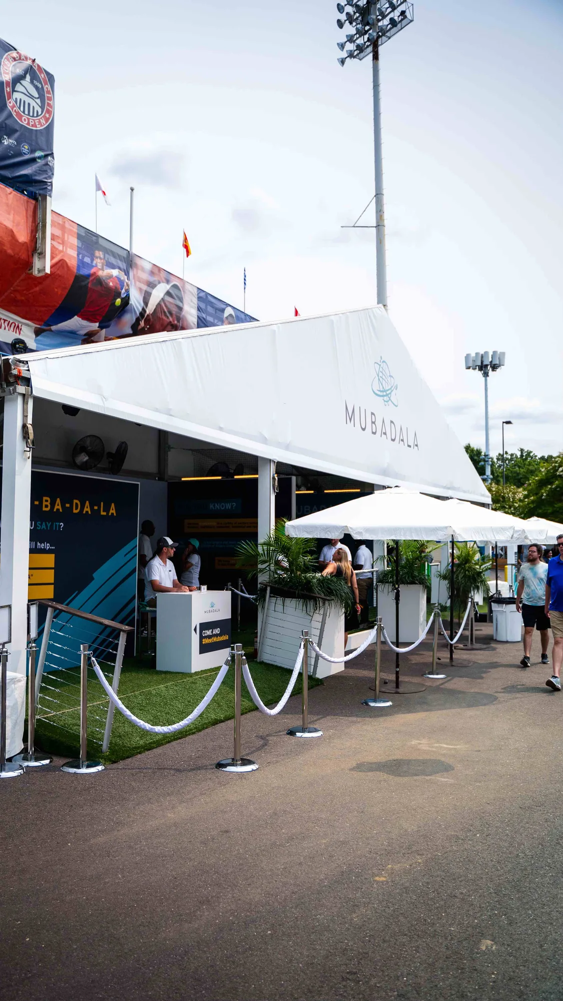 Mubadala branded activation tent exterior entrance with rope stanchions, Citi DC Open 2023, Fitzgerald Tennis Center, EventPro