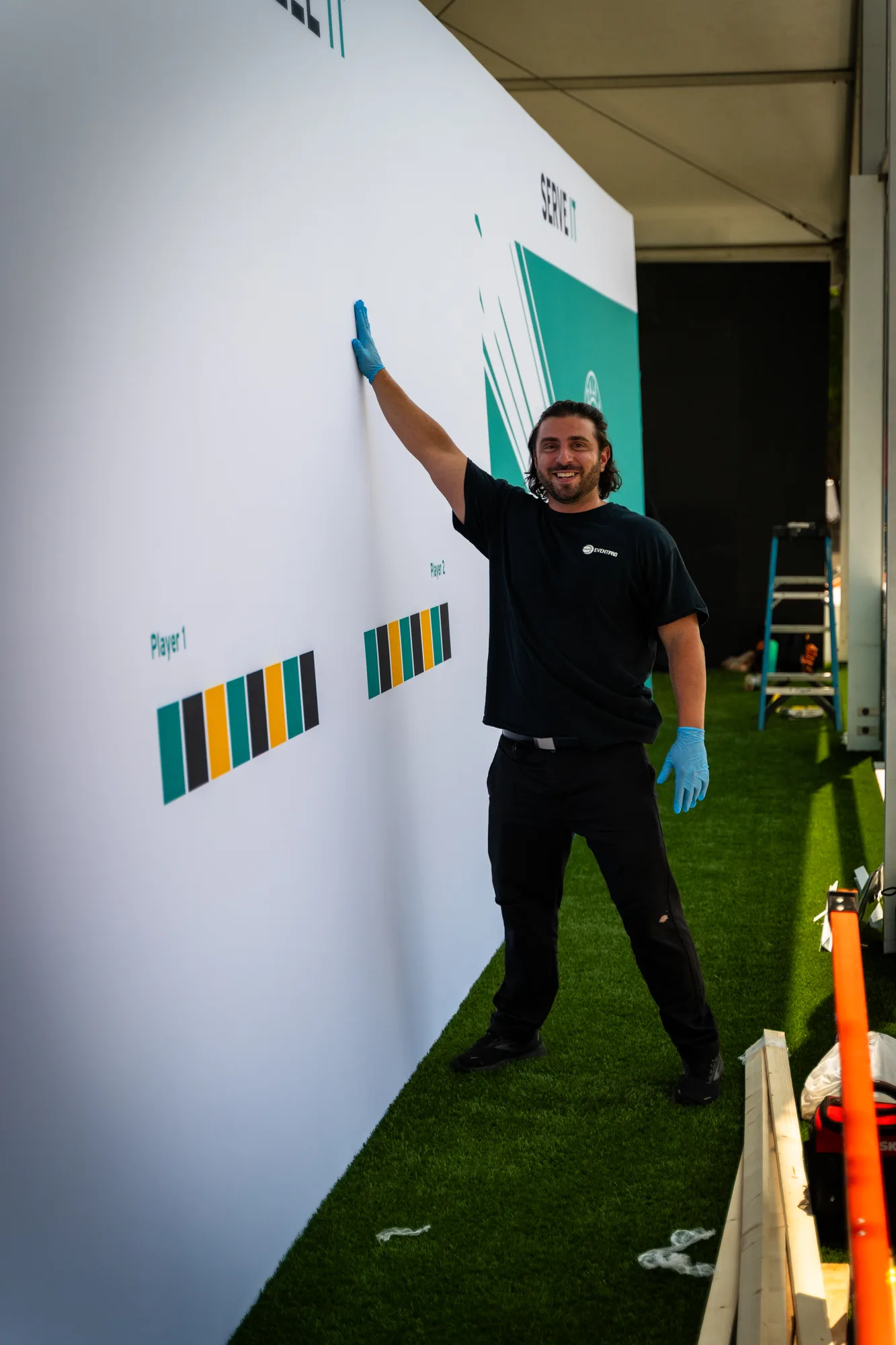EventPro crew installing branded graphic panel at Mubadala activation tent, Citi DC Open 2023, Fitzgerald Tennis Center
