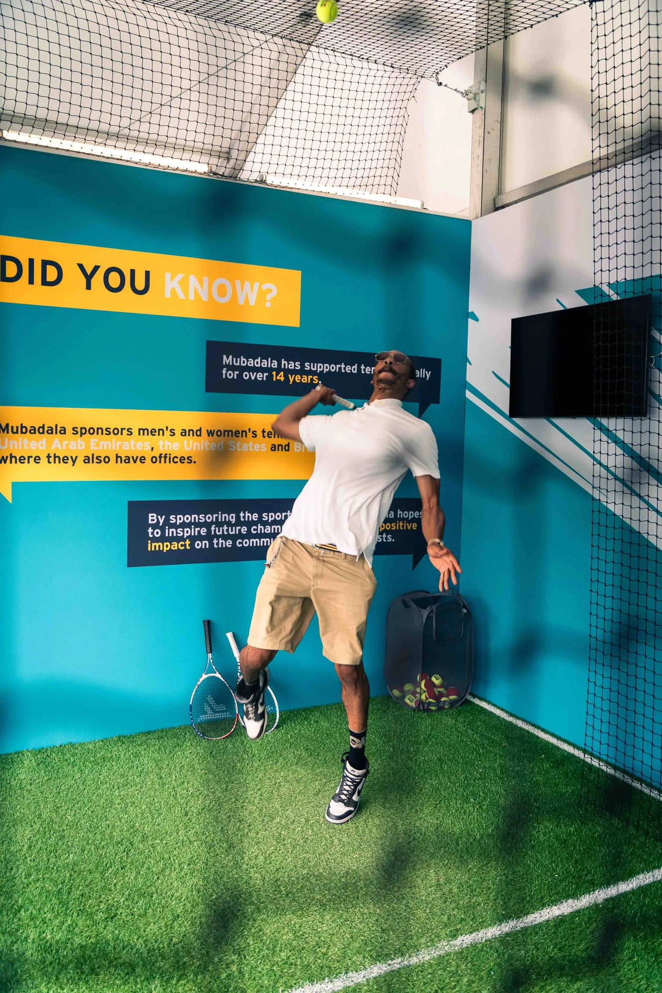 Corner view of Did You Know teal wall and serve activation zone, Mubadala Citi DC Open 2023, EventPro