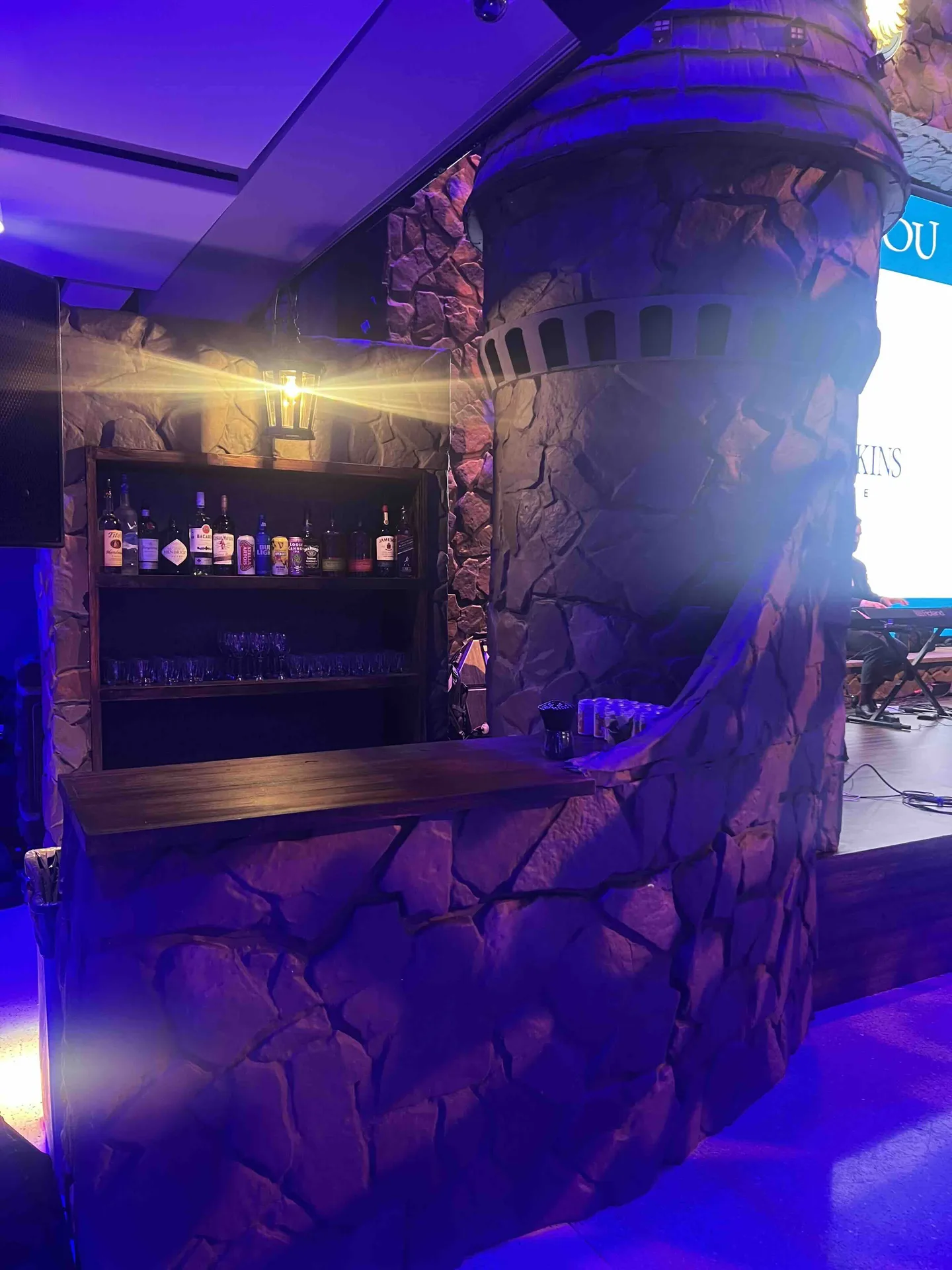 Custom fabricated stone castle tower bar, wooden bar top, lantern lighting, textured stonework, Mt. Washington Pediatric Hospital Storybook Gala, EventPro fabrication Maryland