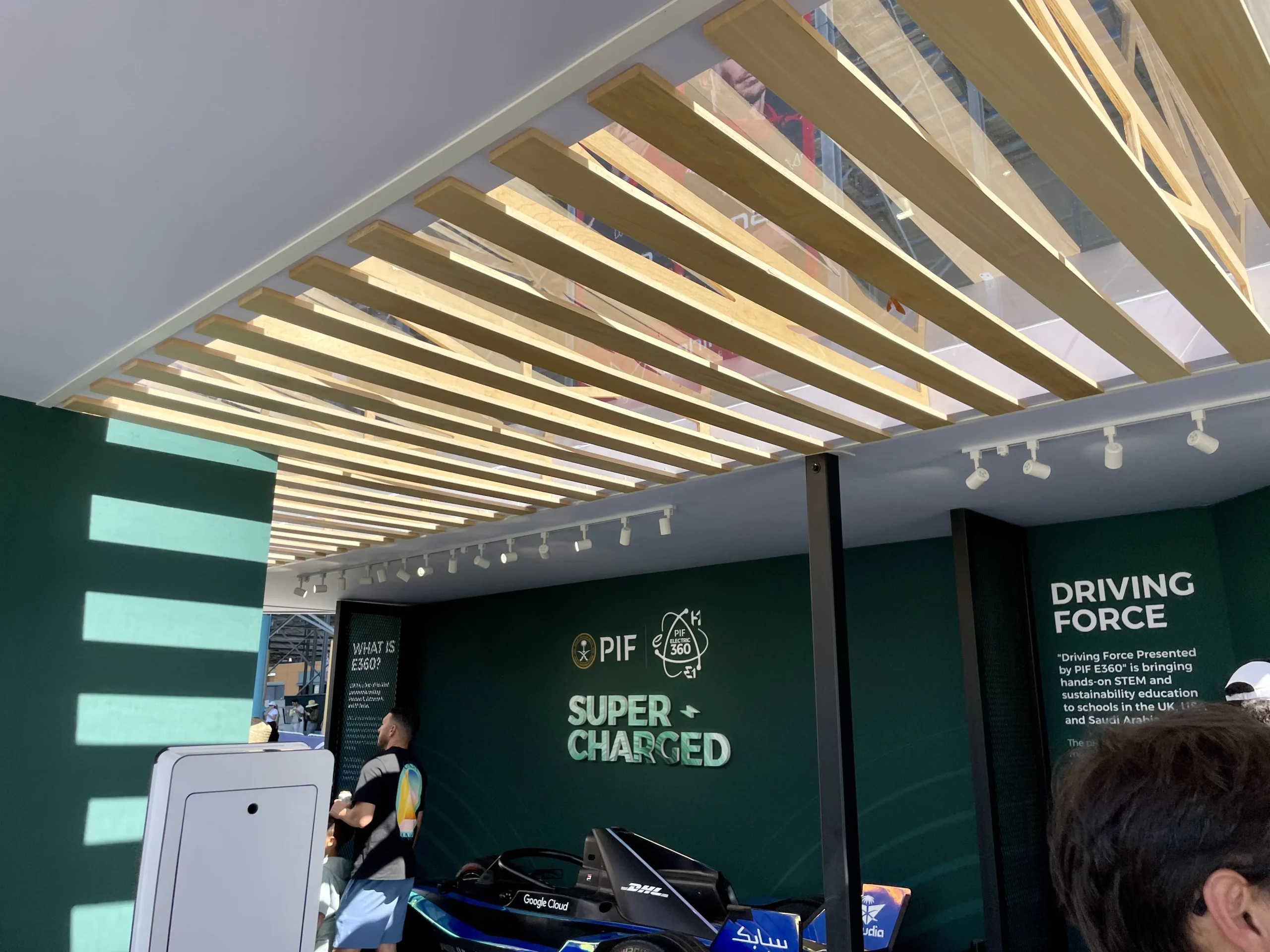 Custom slatted wood ceiling with integrated track lighting inside PIF Super Charged pavilion, Miami Formula ePrix 2025, EventPro