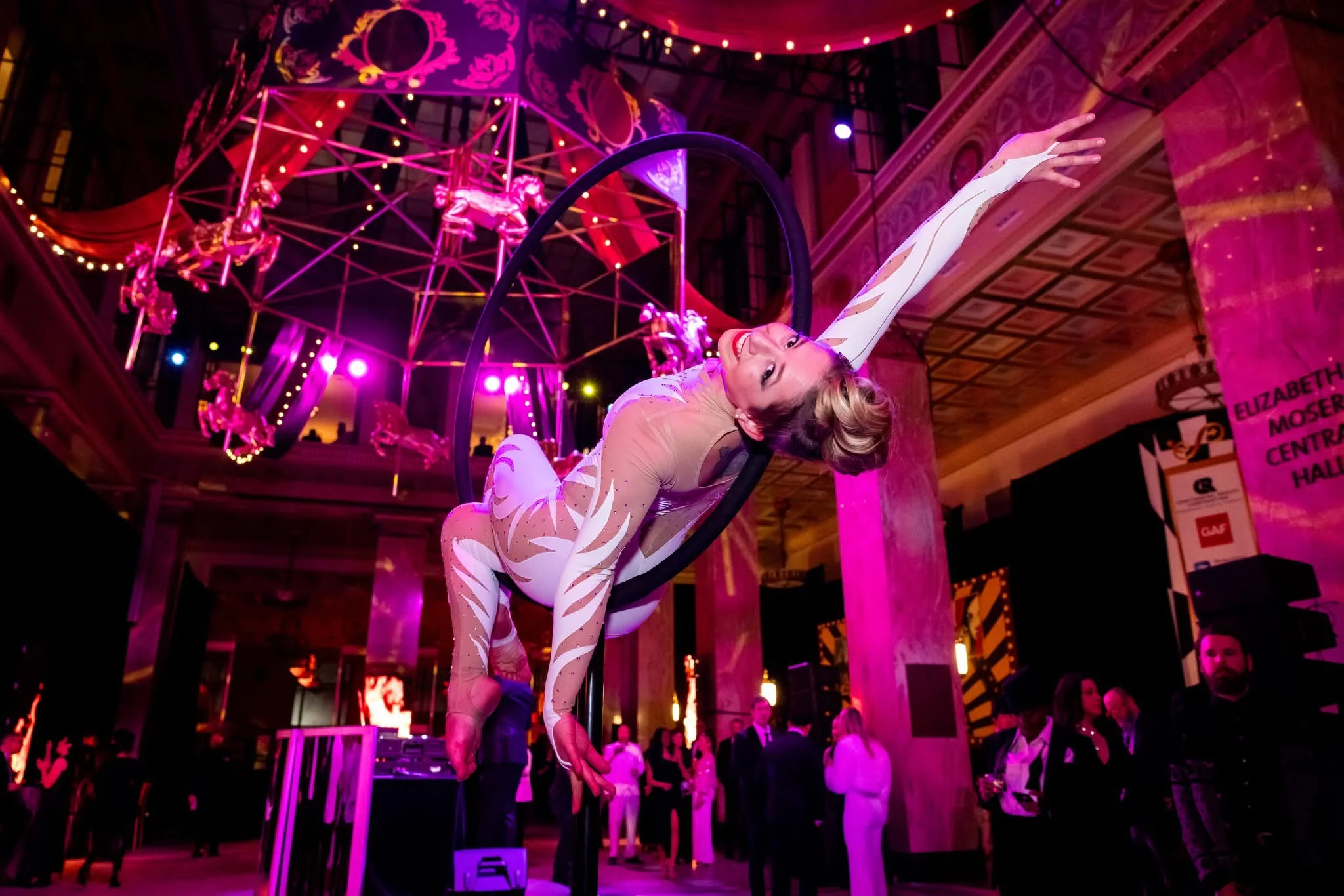 Aerial lyra performer side bend in Moser Central Hall — Pratt Library Black and White Party — EventPro