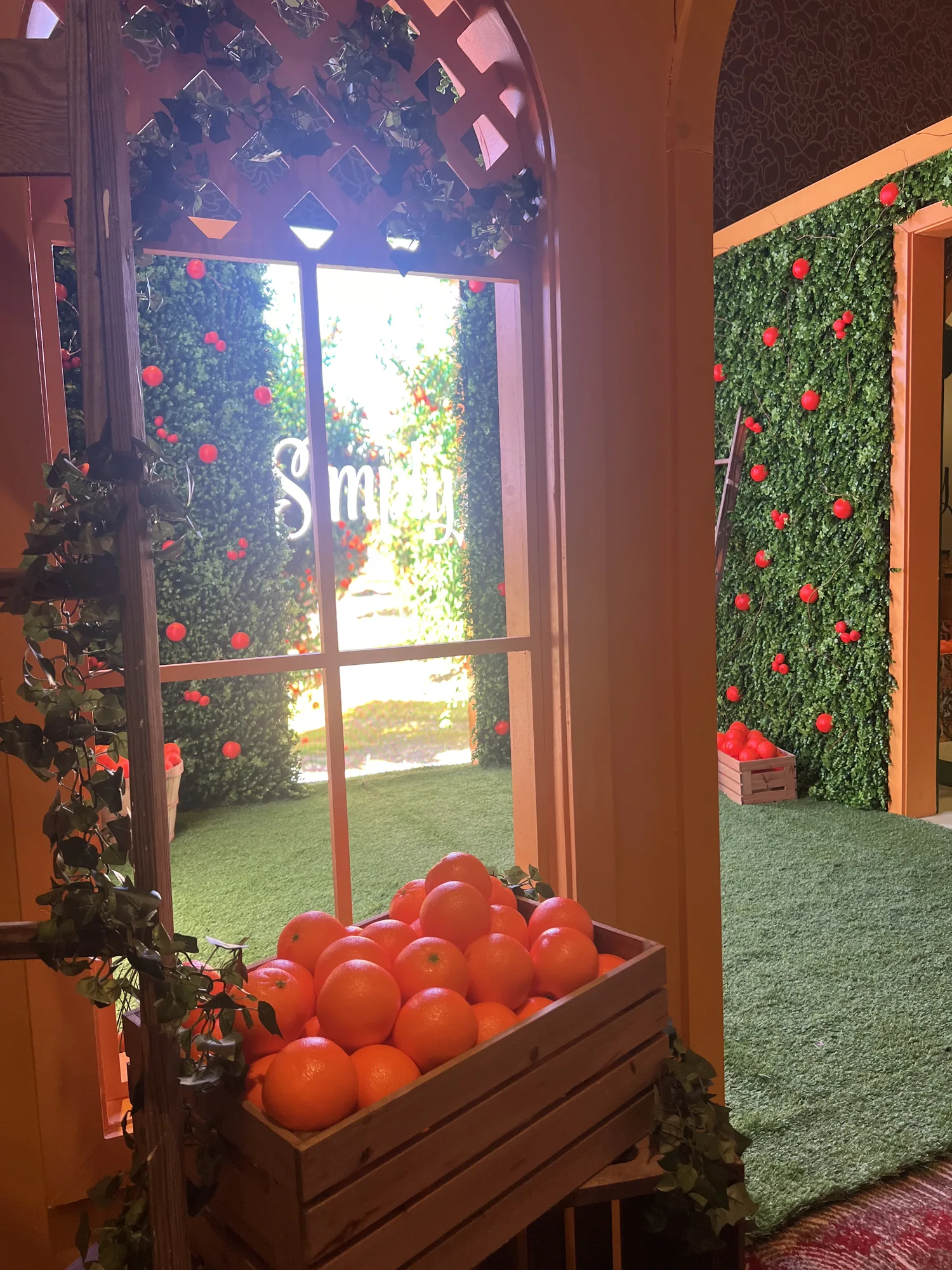 Simply orange grove arch with orange crate and hedgerow wall detail, brand activation Hard Rock Hotel Miami Gardens 2024, EventPro