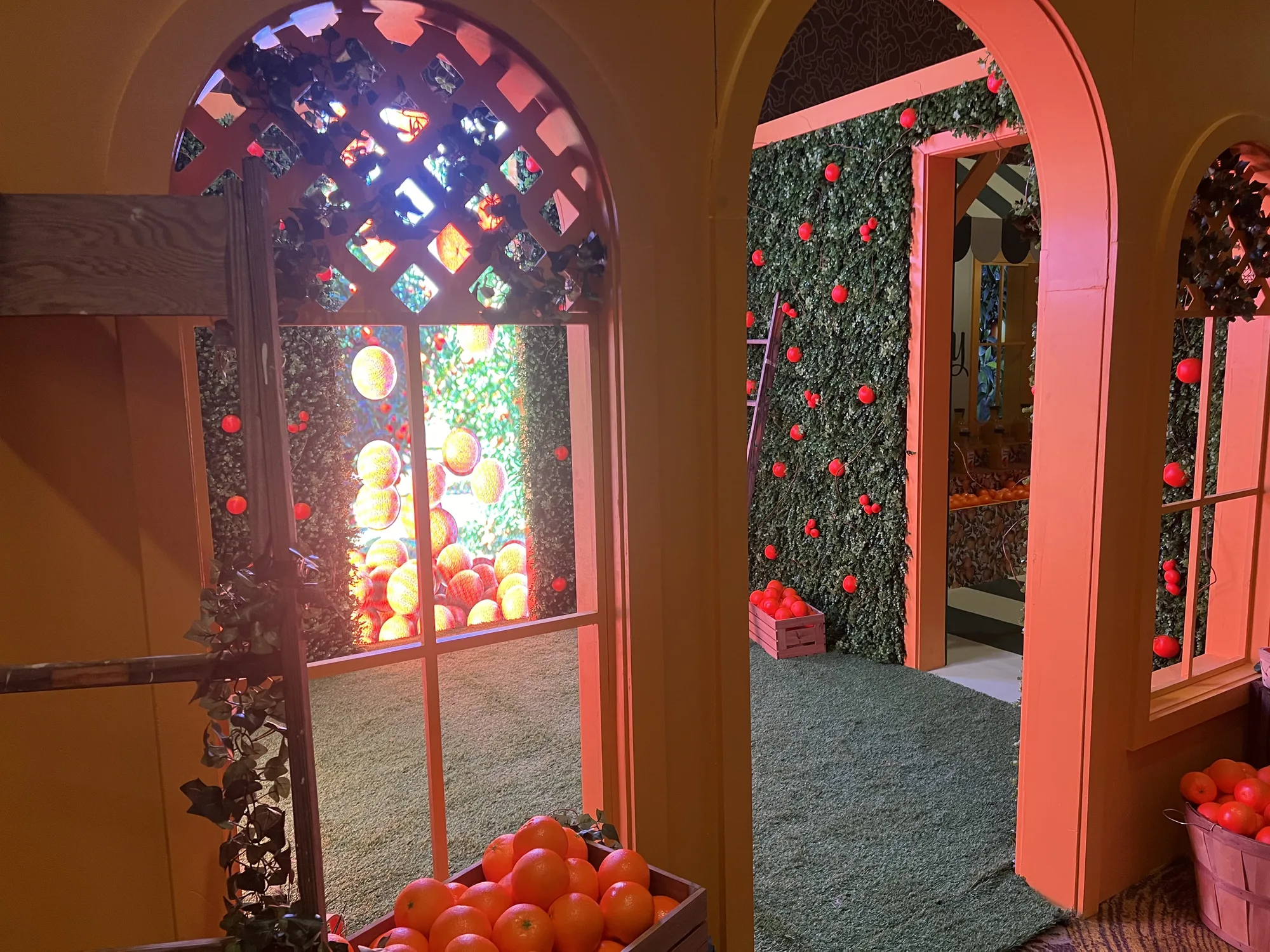 Simply activation orange grove passage with double arched doorways and hedgerow walls embedded with oranges, Hard Rock Miami Gardens, EventPro