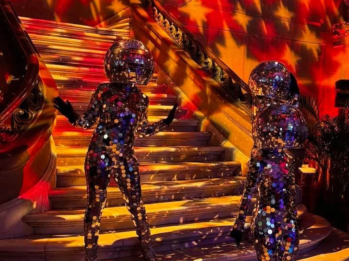 Star gobo pattern projected across ornate staircase with red and orange wash lighting by Event Pro