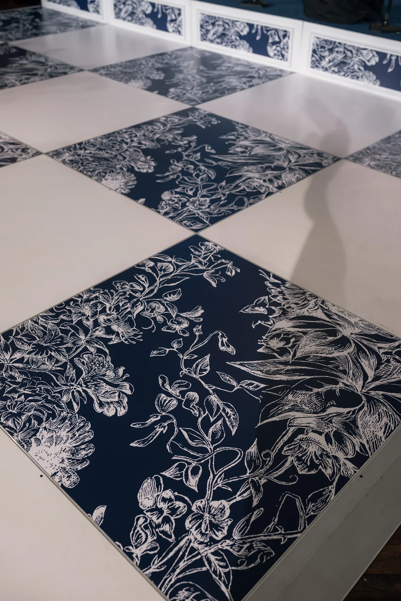 Custom graphic printed dance floor tile detail, navy and white botanical floral checkered pattern, EventPro wedding production Brittland Estates Maryland