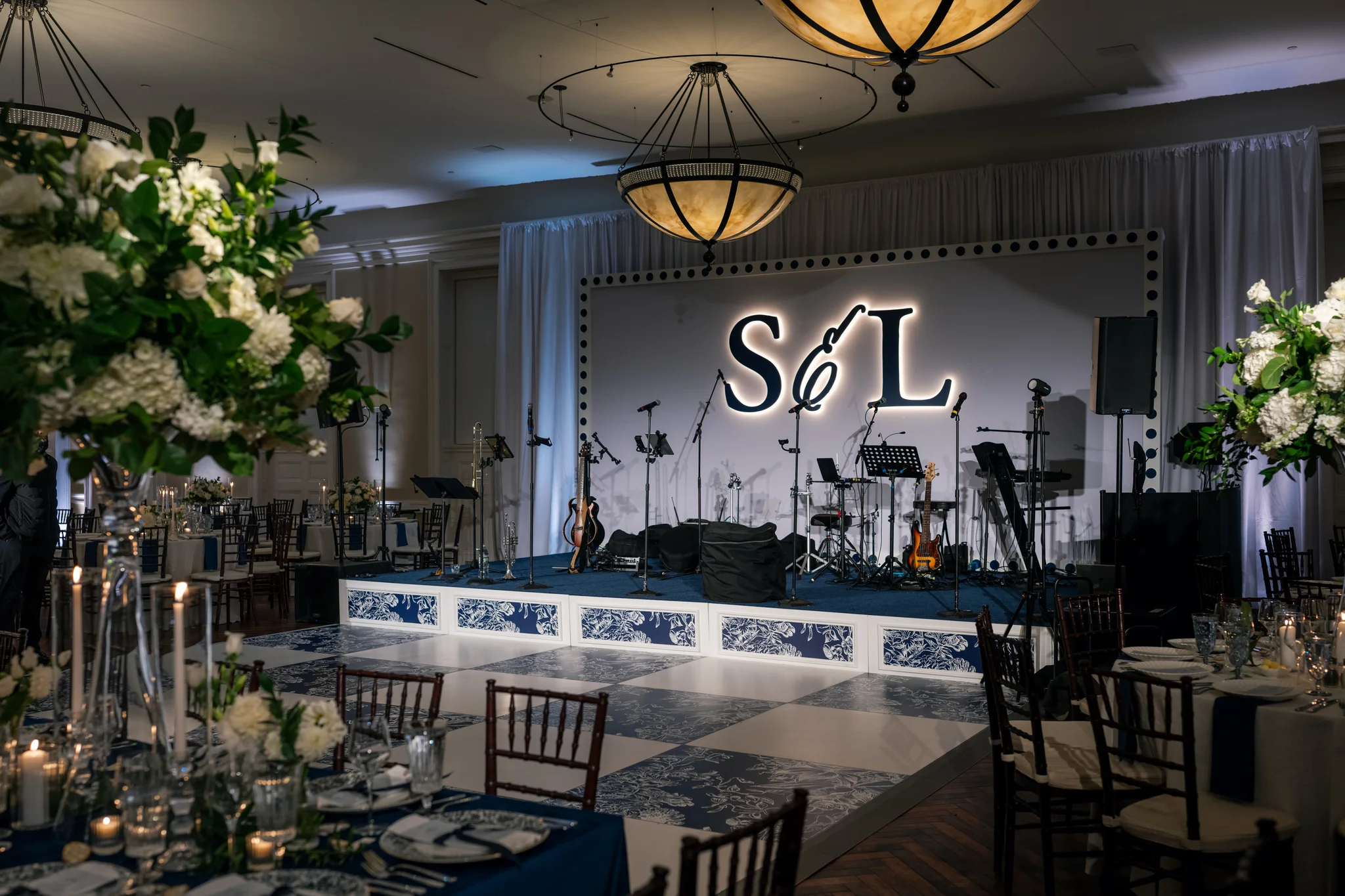 S&L wedding reception at Brittland Estates Maryland, custom stage with LED-backlit CNC monogram backdrop, navy and white custom printed dance floor, full band, EventPro event production Maryland