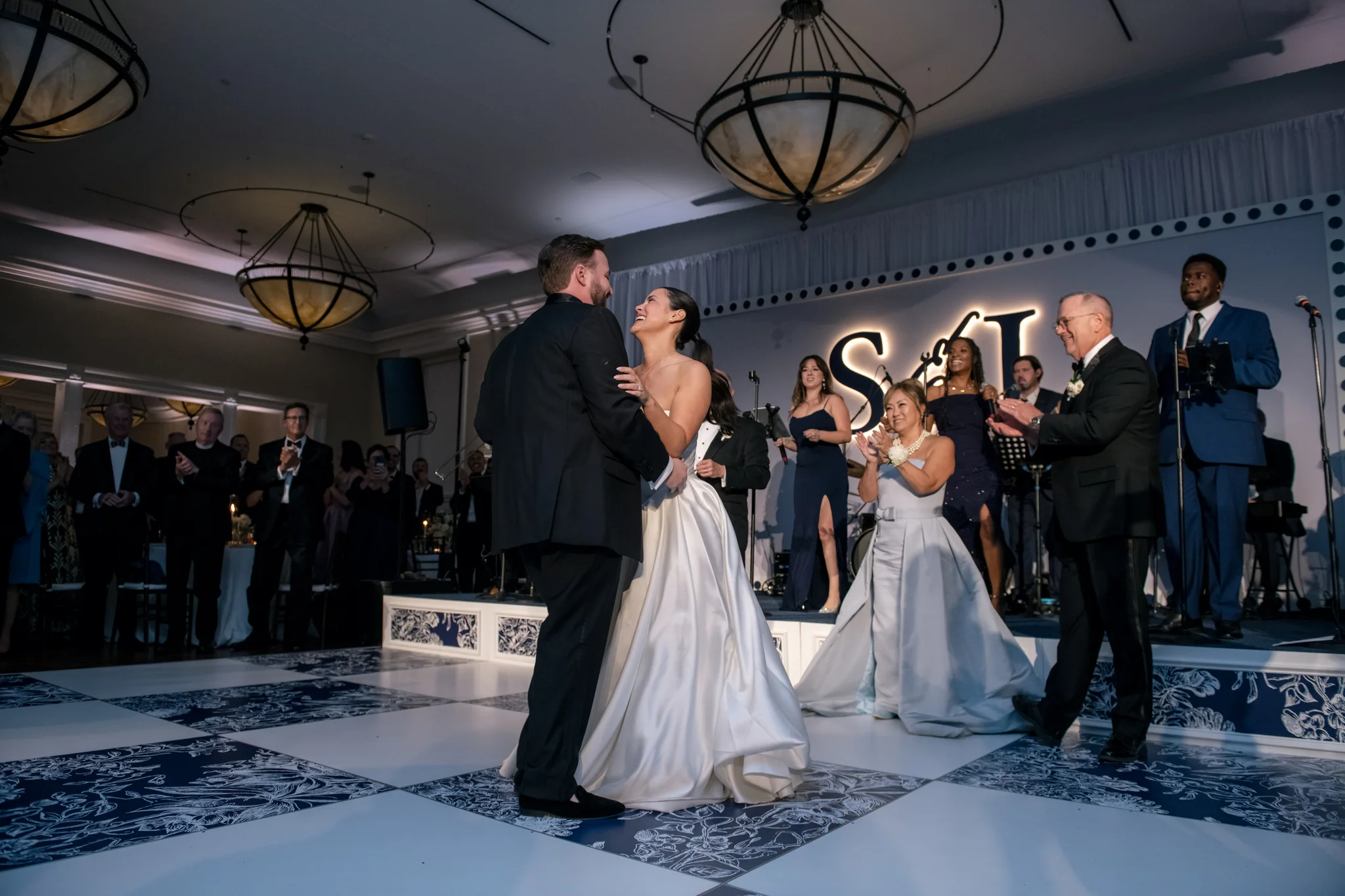 First dance on custom printed dance floor at Brittland Estates Maryland wedding, navy and white floral checkered tiles, S&L monogram backdrop, EventPro wedding production