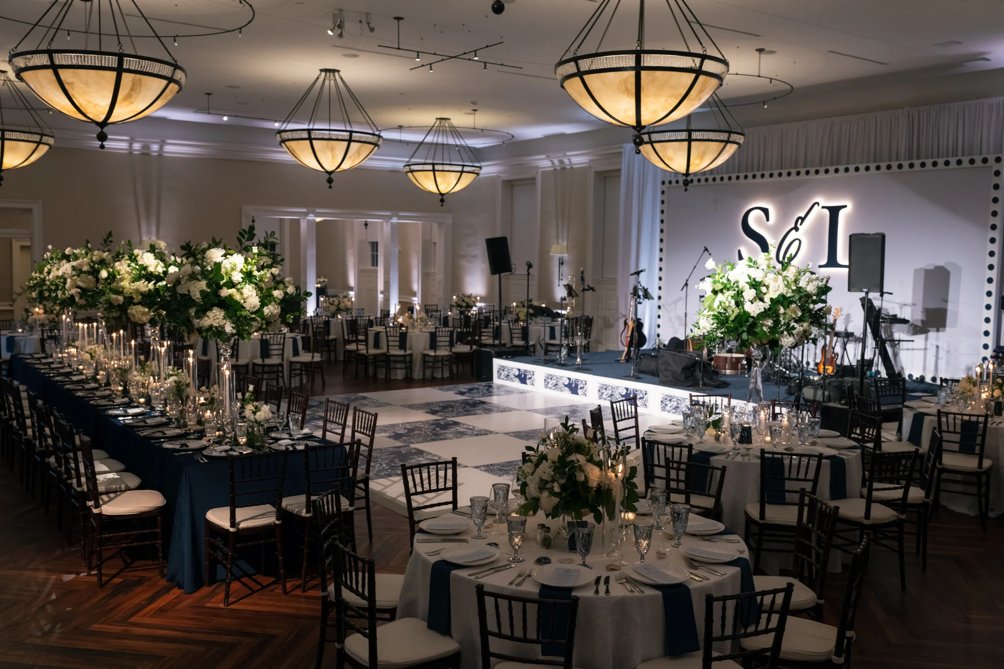 Brittland Estates Maryland wedding reception, full ballroom overview with custom stage backdrop, navy perimeter uplights, custom dance floor, EventPro event production