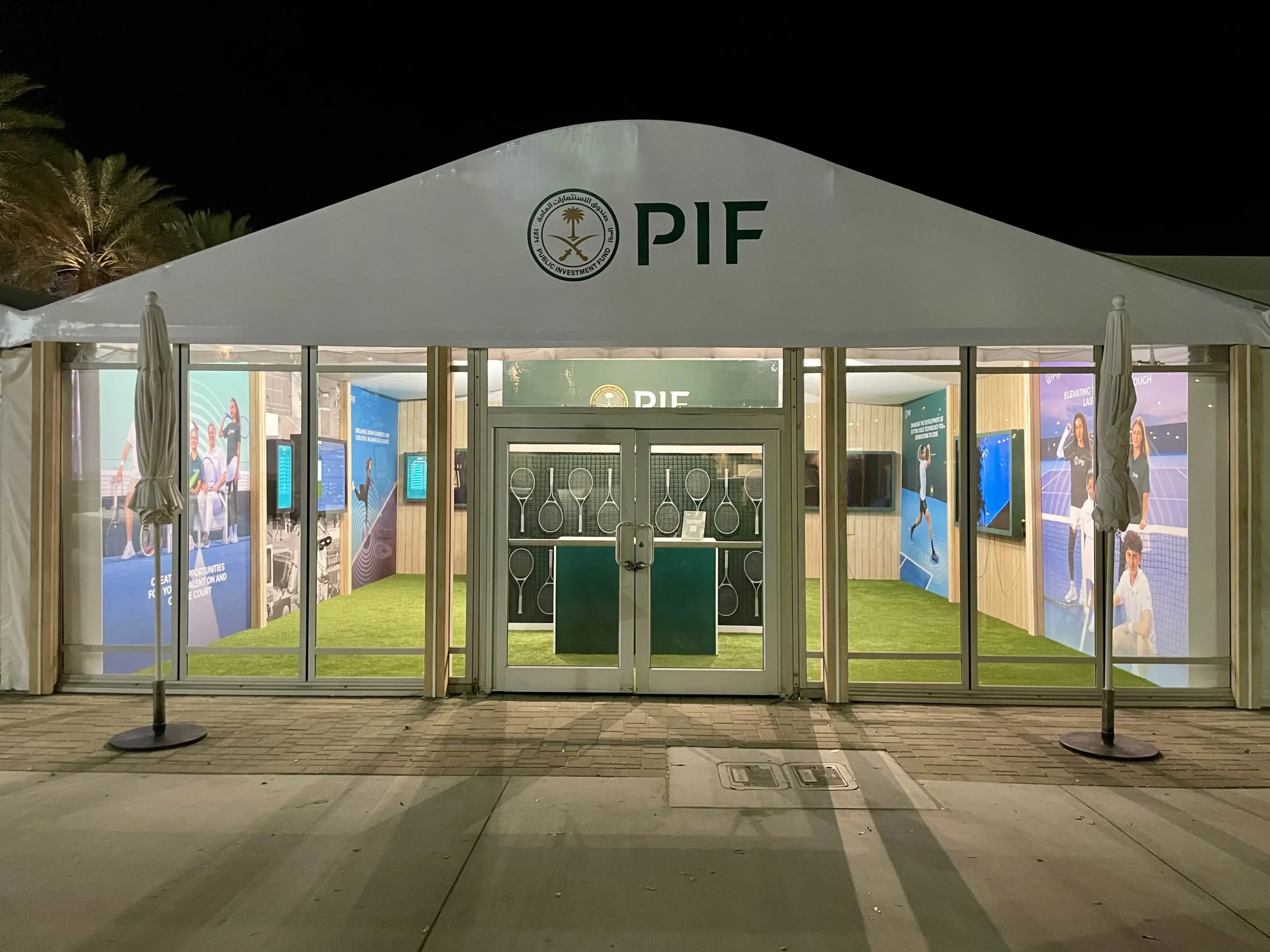 PIF branded tent exterior with large format printed graphics at night